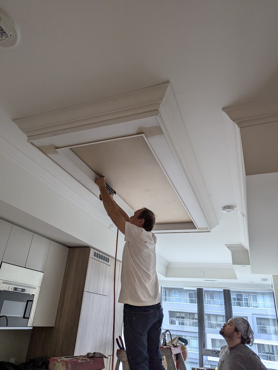 Crown moulding installation in progress in a Toronto home