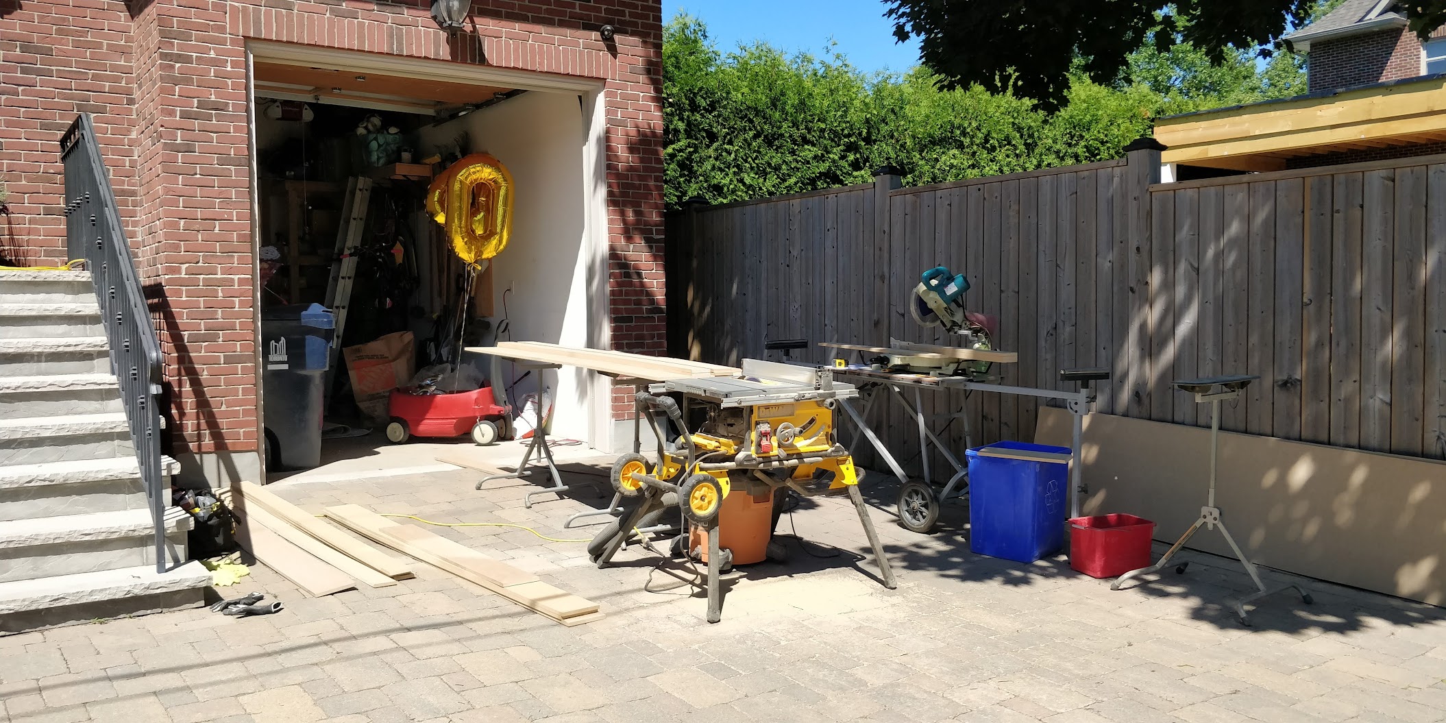 Table saw and mitre saw set up in a GTA home driveway for a summer finish carpentry job