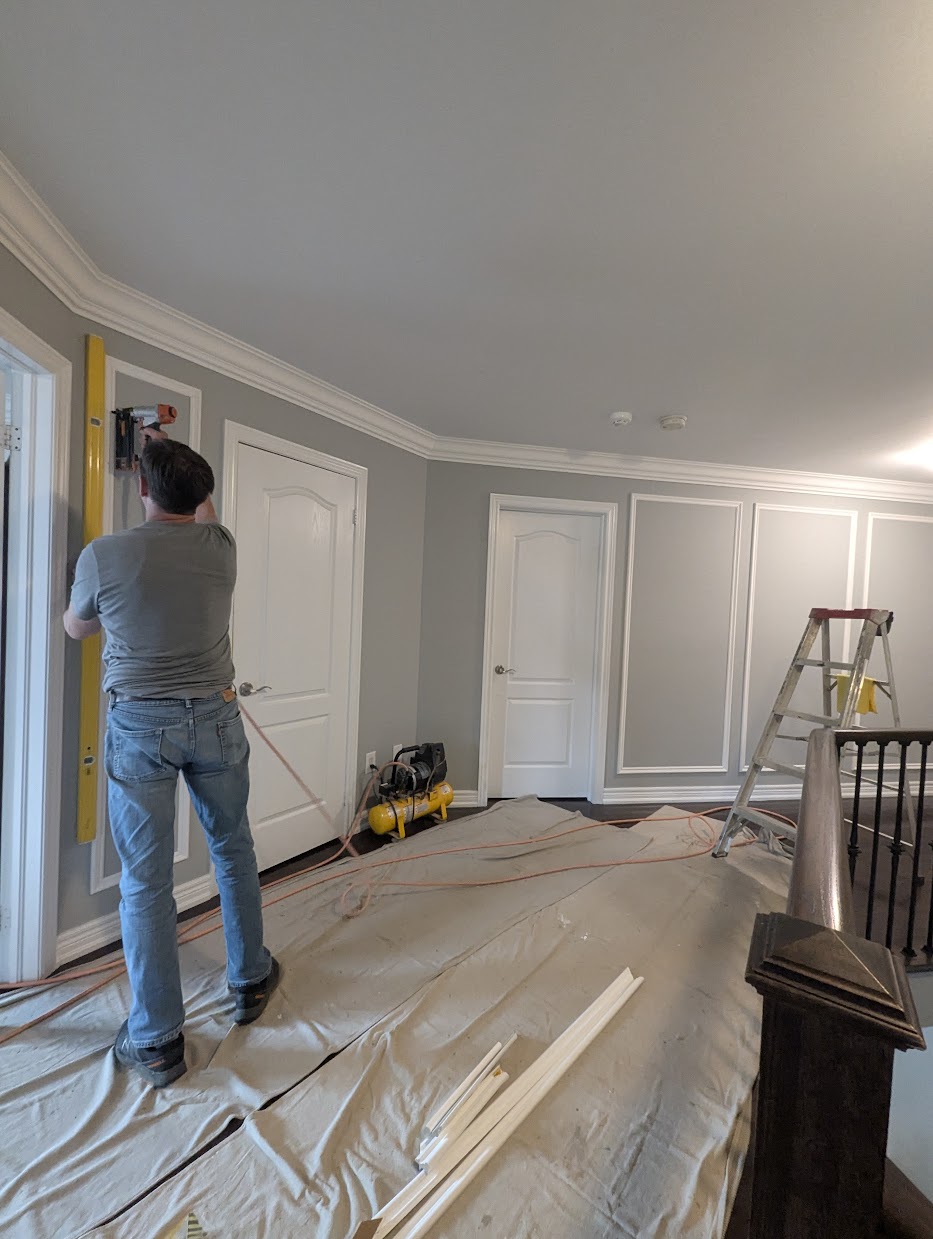 Picture-frame wainscoting layout on a GTA living room wall