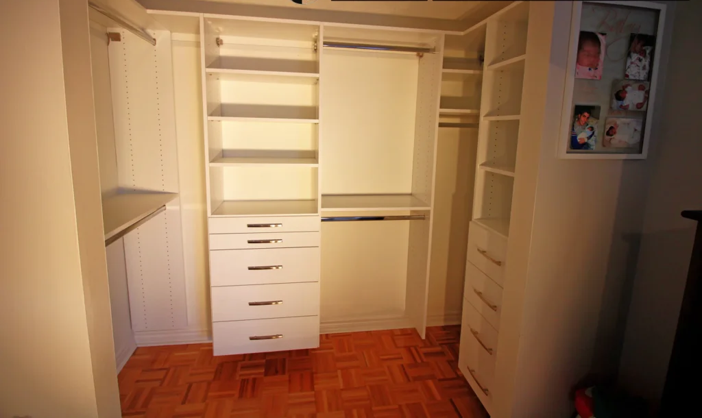 Walk-in closet with island, shoe wall, hanging sections, and integrated lighting in a Toronto primary suite
