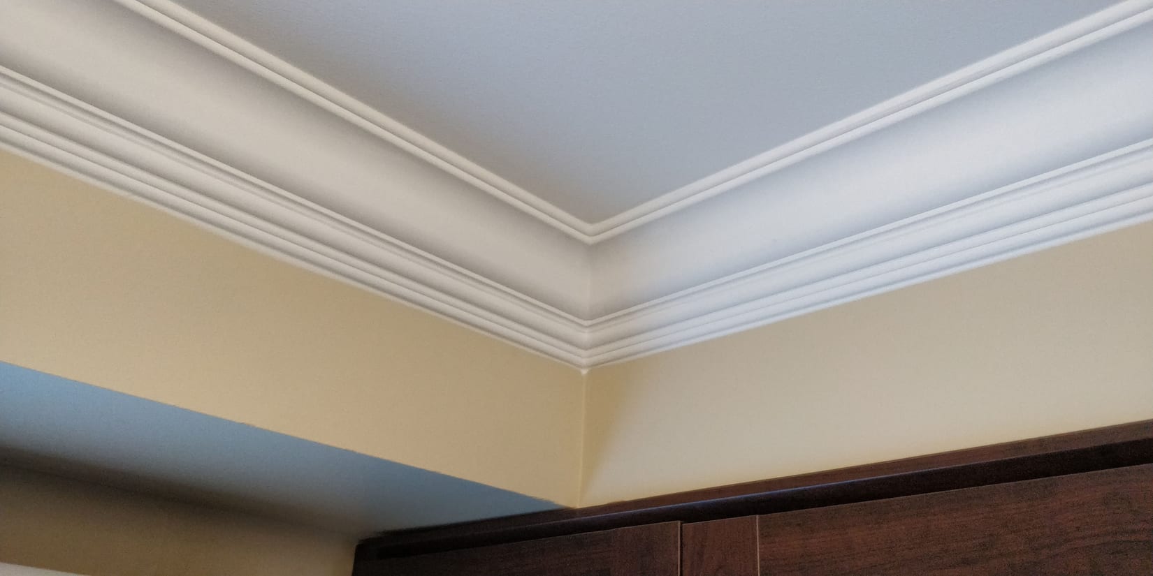 Five-inch Tuscany crown moulding returning around a condo bulkhead, a Mississauga condo trim option