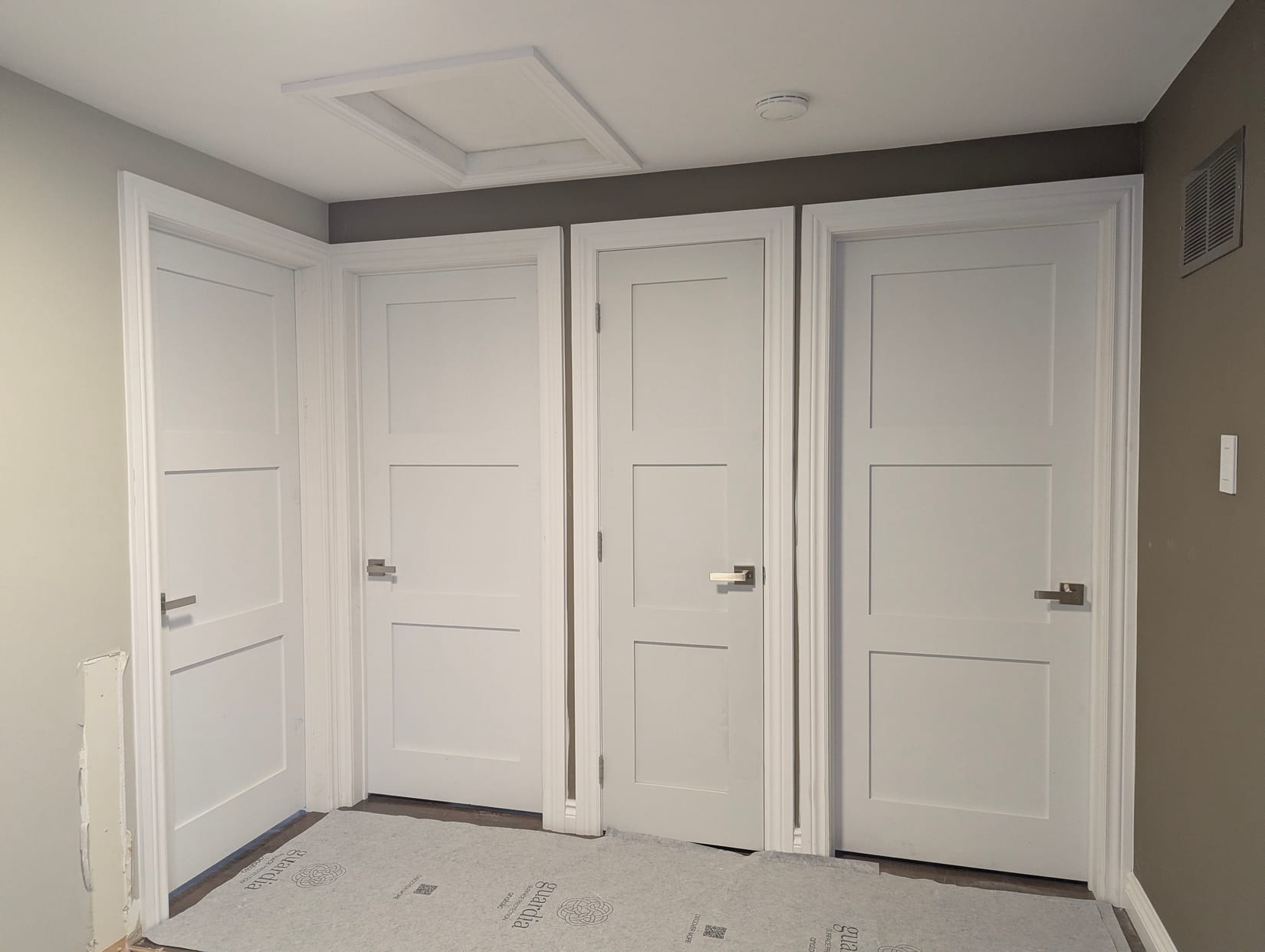 Four panelled interior doors with casing installed in a Mississauga hallway