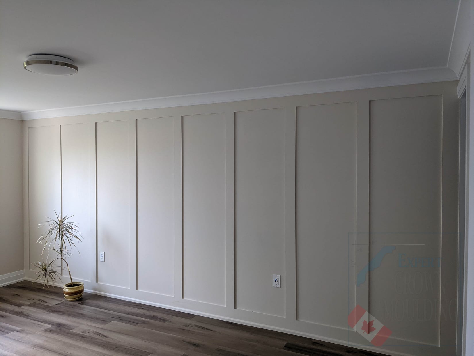 Full-height board and batten wall with crown moulding in an Oakville home