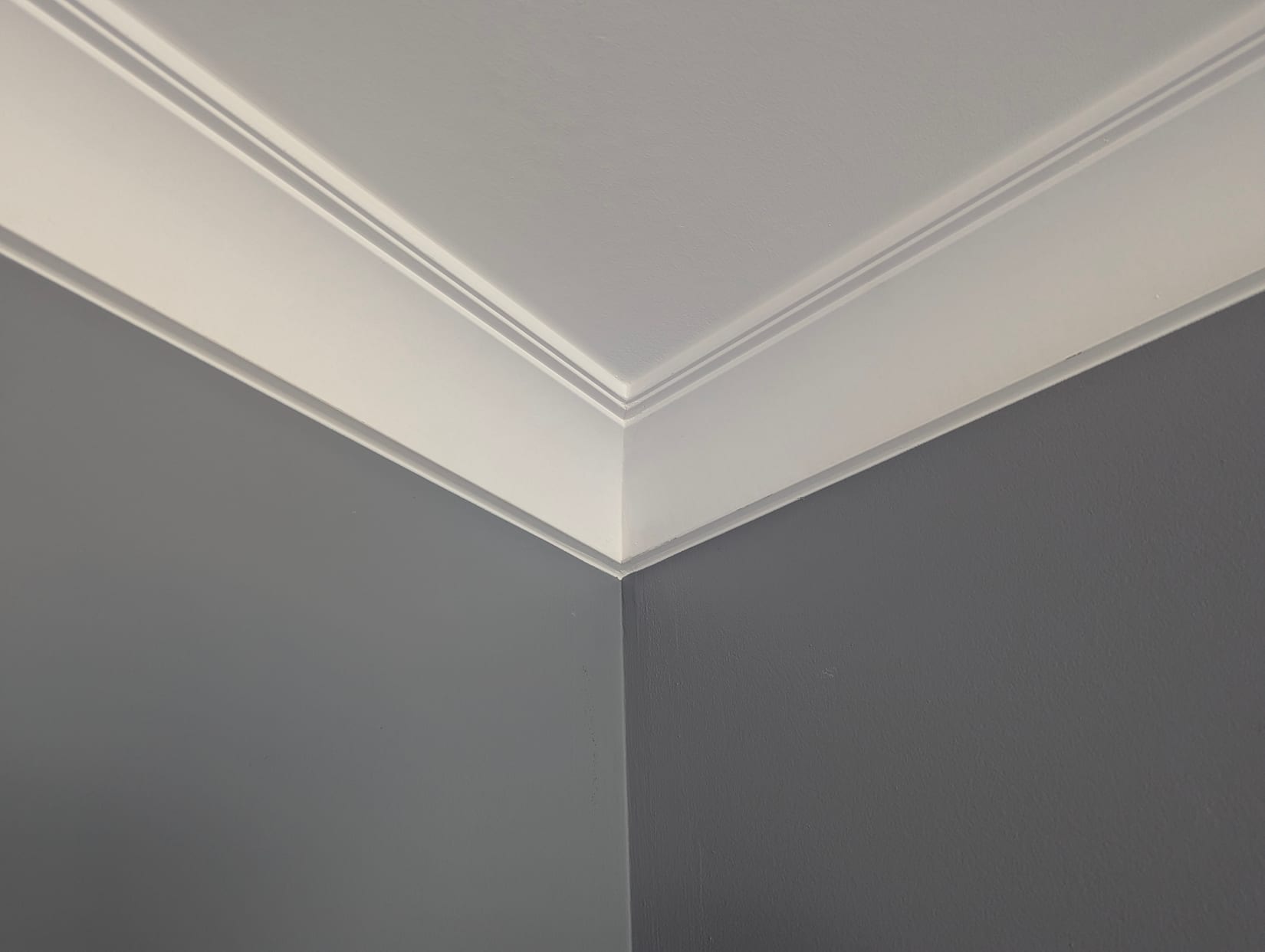 Painted crown moulding meeting at an inside corner in an Oakville home