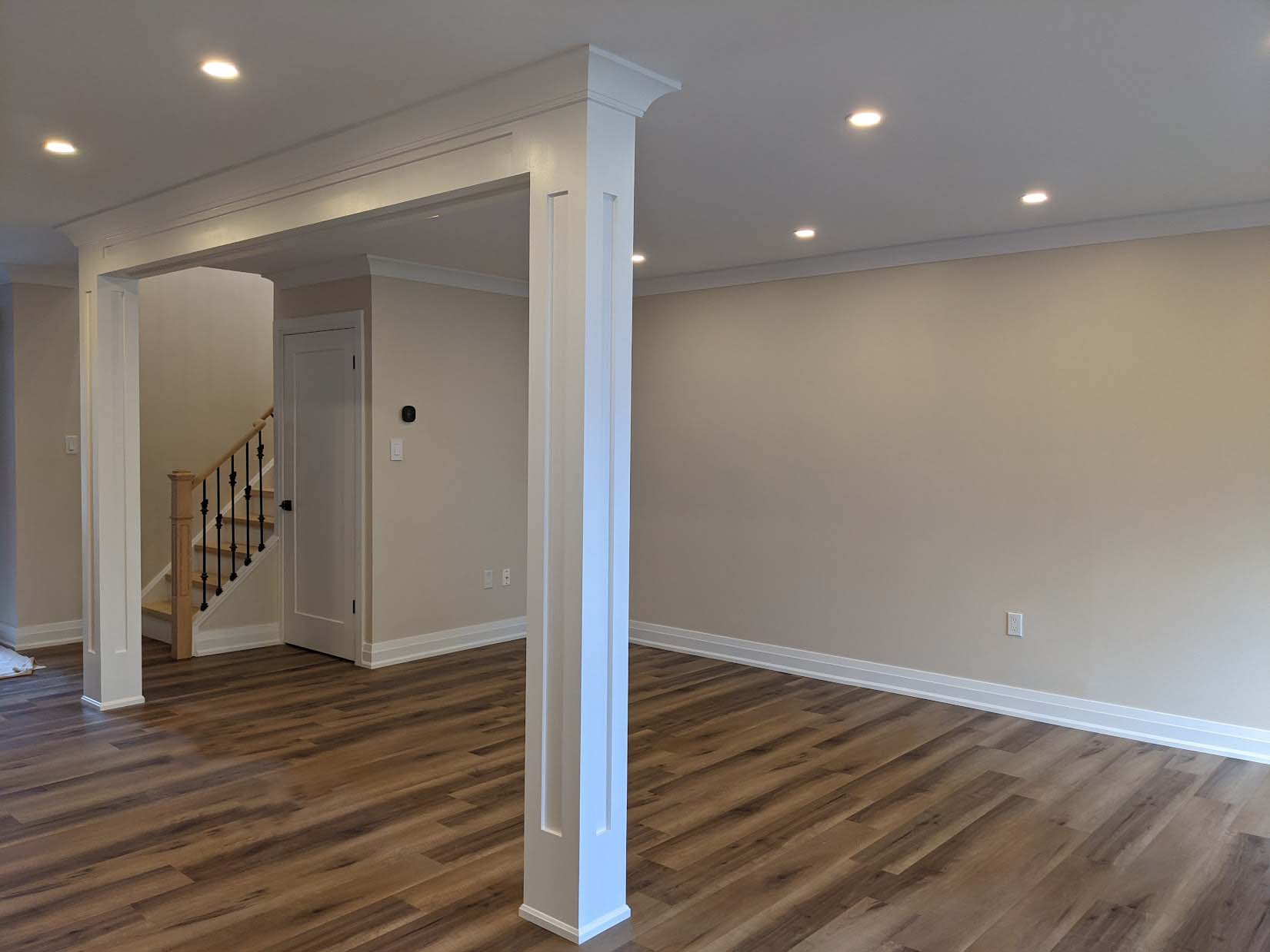Custom finished room with crown moulding, baseboards, and architectural columns — Toronto trim installation
